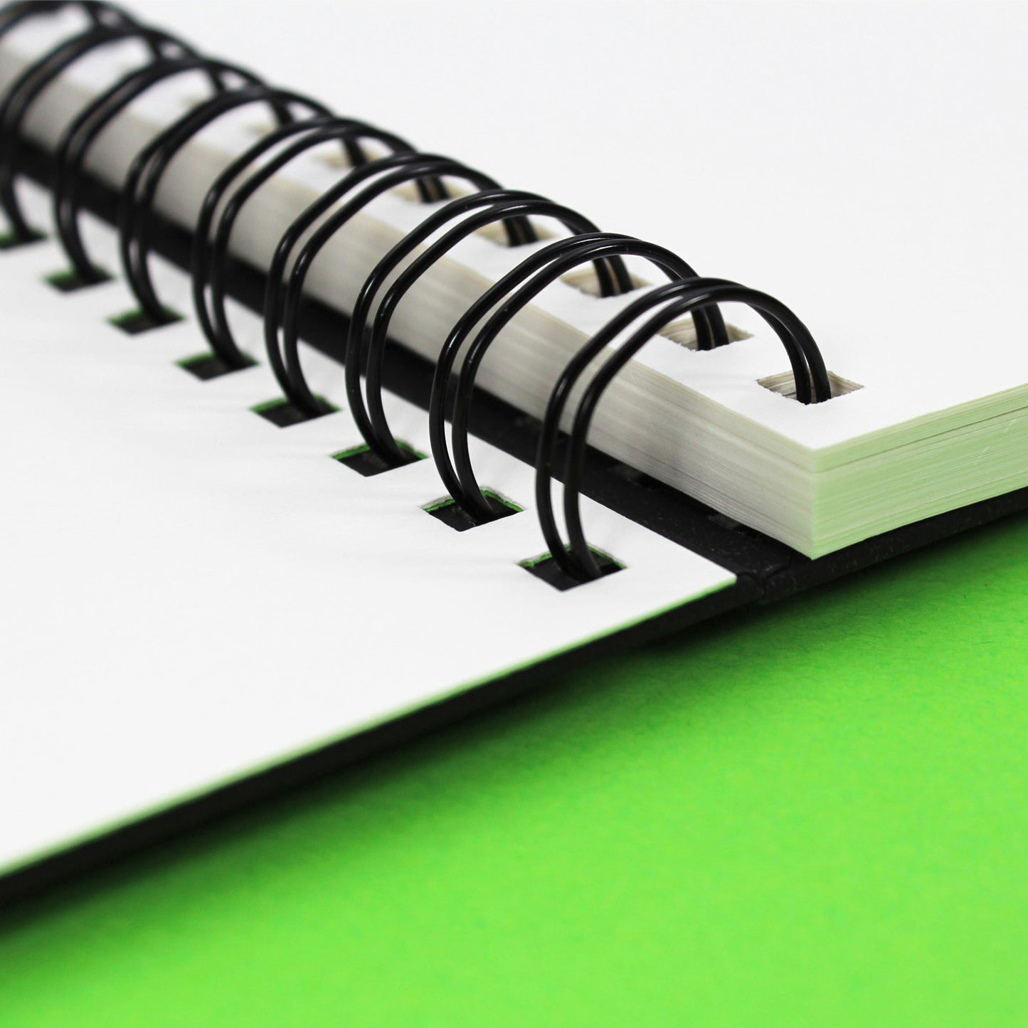 Freestyle Sketchbook open to show the 250gsm smooth paint marker paper on green background.