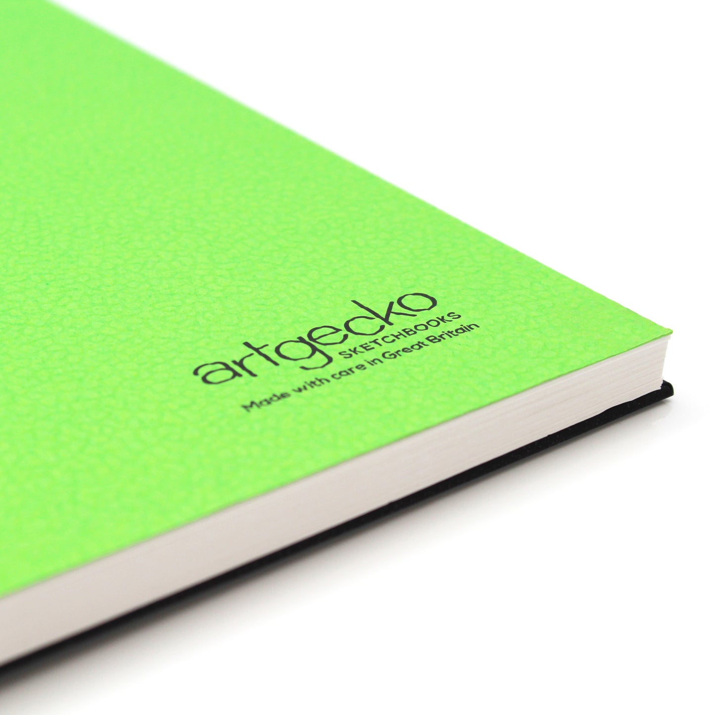 Close up of the corner of sketchbook with green textured cover sheet on show and Artgecko branding.