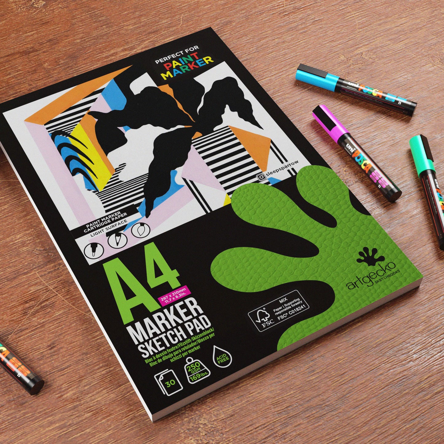 A4 ArtGecko marker sketch pad with colourful markers on a wooden surface