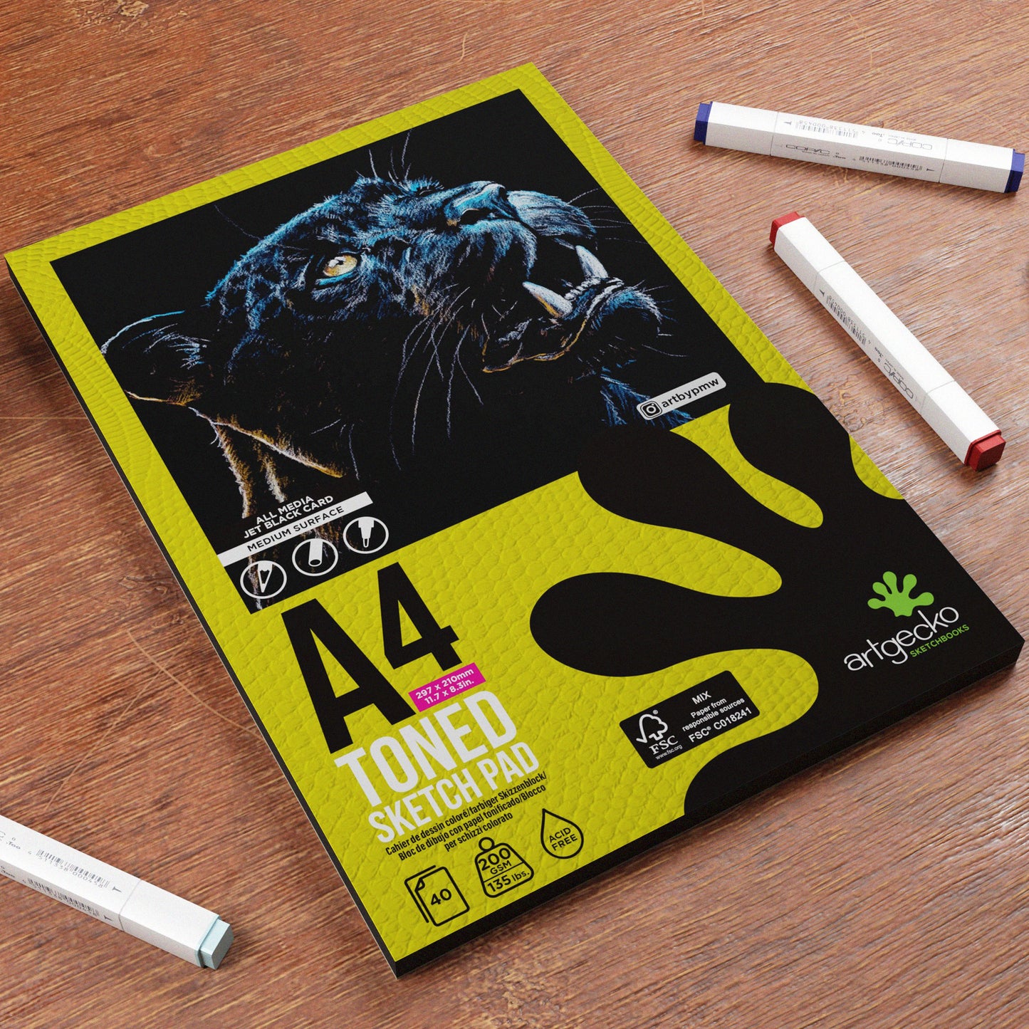 A4 toned sketch pad with a panther design on a wooden surface with markers.