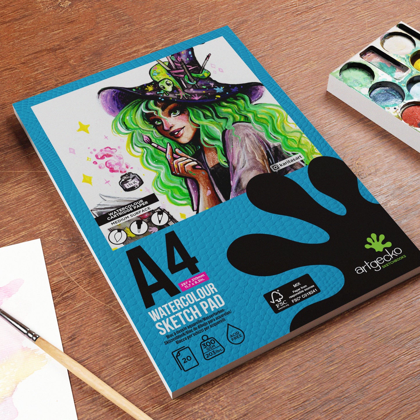 A4 ArtGecko watercolour sketch pad with a colourful illustration on the cover, placed on a wooden surface.