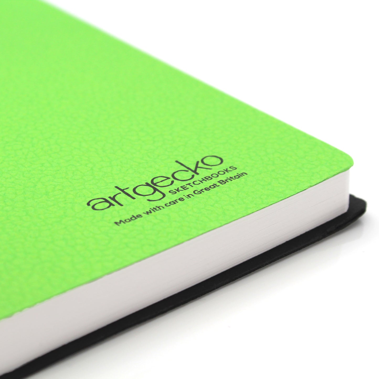 Close up of the corner of 'Swanky' all media sketchbook with green textured cover sheet on show and Artgecko branding.