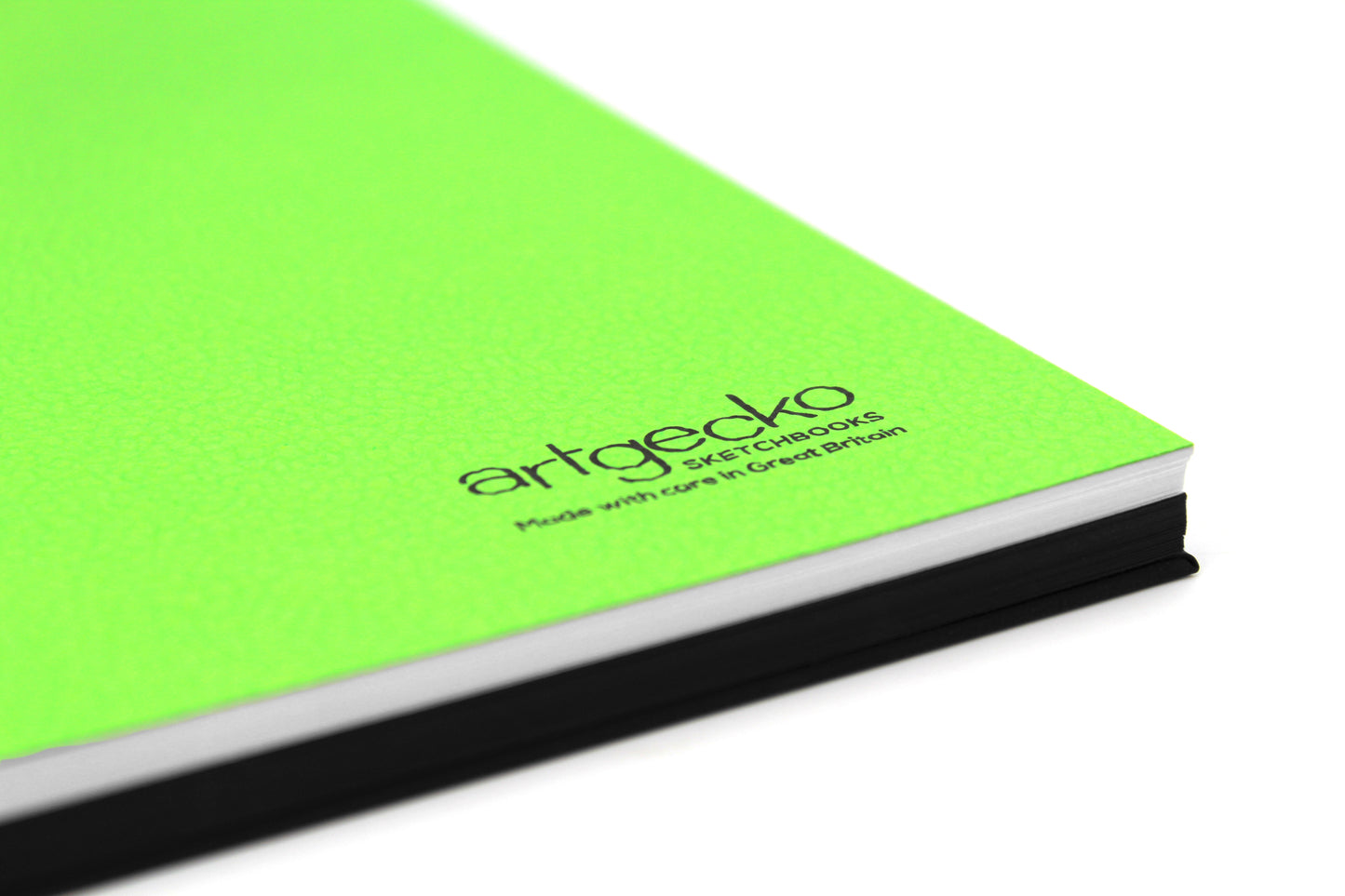 Close up of the corner of 'Stocky' all media sketchbook with green textured cover sheet on show and Artgecko branding.